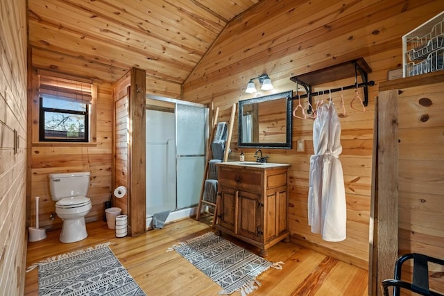 bathroom with wooden walls, vaulted ceiling, a shower stall, wood-type flooring, and wooden ceiling