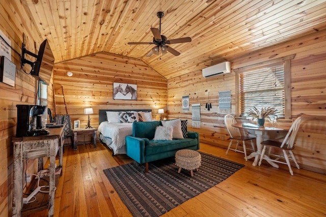 bedroom featuring wooden walls, a wall mounted AC, wood-type flooring, and vaulted ceiling