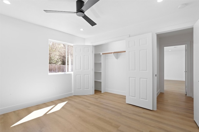 unfurnished bedroom featuring recessed lighting, light wood-type flooring, baseboards, and a closet