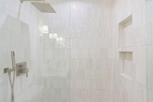 interior details featuring tiled shower