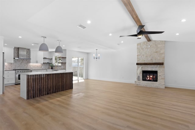 kitchen with open shelves, tasteful backsplash, stainless steel electric stove, wall chimney range hood, and vaulted ceiling with beams