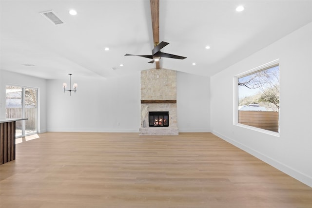 unfurnished living room with baseboards, visible vents, light wood finished floors, lofted ceiling with beams, and ceiling fan with notable chandelier