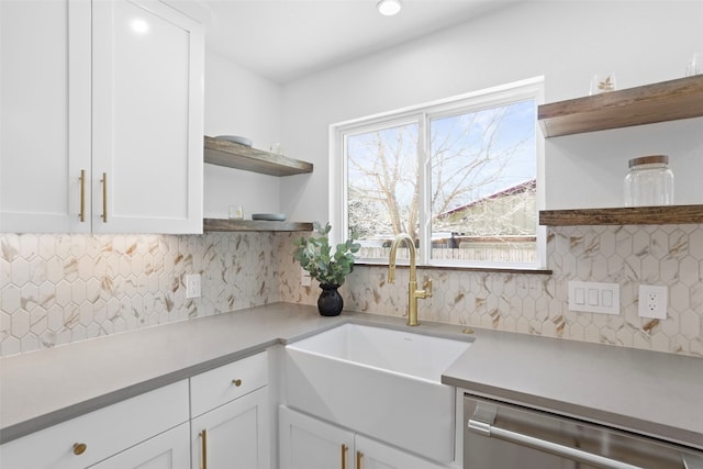 kitchen featuring open shelves, dishwasher, white cabinets, and a sink