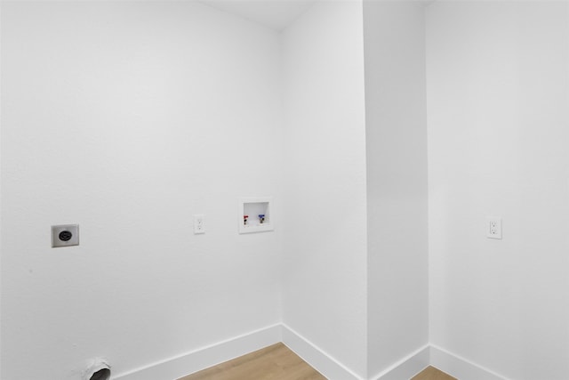 laundry area with hookup for a washing machine, baseboards, hookup for an electric dryer, laundry area, and light wood-style floors