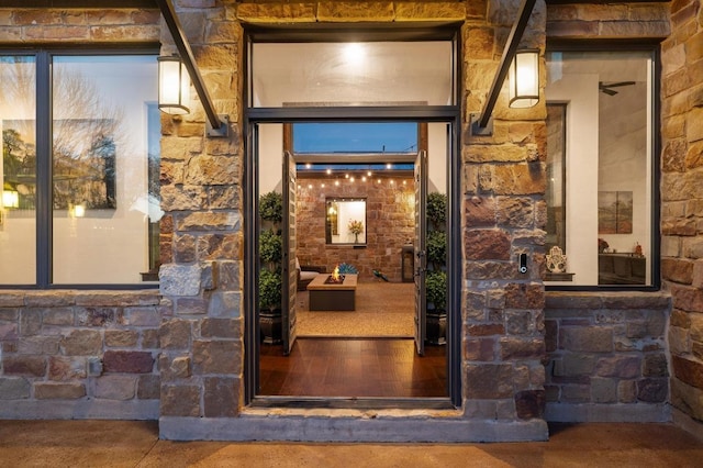 property entrance featuring stone siding