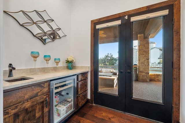 bar featuring a sink, french doors, wine cooler, bar area, and a healthy amount of sunlight