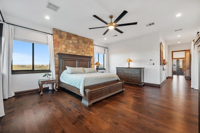 bedroom featuring multiple windows, dark wood-style floors, and visible vents