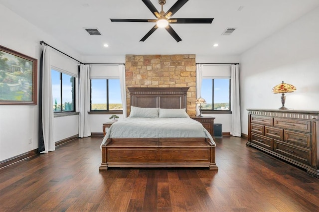 bedroom with dark wood finished floors, visible vents, and multiple windows