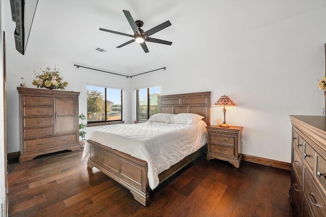 bedroom with dark wood finished floors, visible vents, a ceiling fan, and baseboards