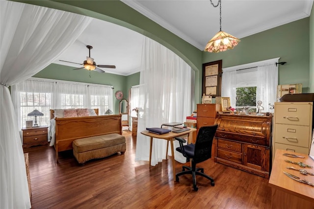 bedroom featuring arched walkways, wood finished floors, and crown molding