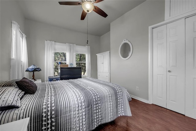 bedroom with ceiling fan, baseboards, and wood finished floors