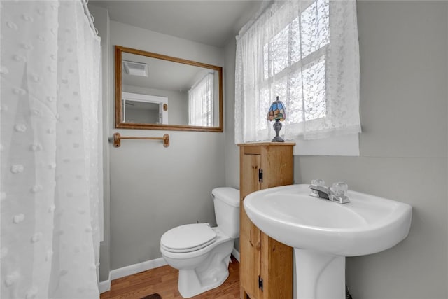 full bath with visible vents, toilet, baseboards, and wood finished floors