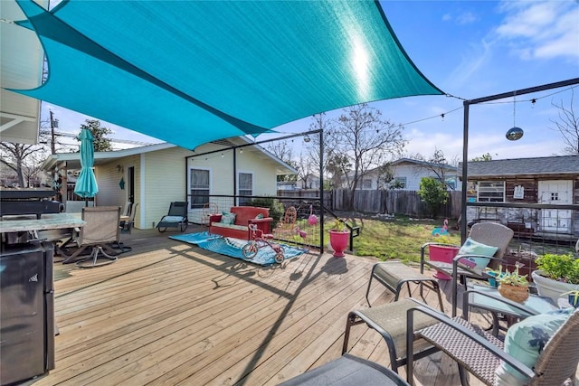 deck with outdoor dining area and fence