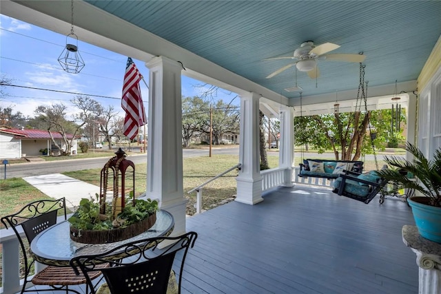 sunroom / solarium featuring a ceiling fan and ornate columns