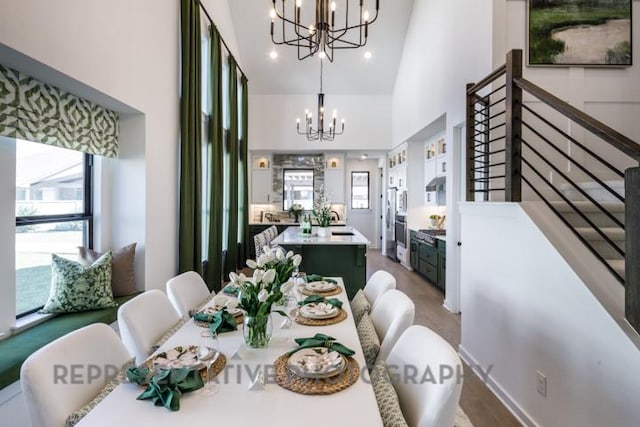 dining area with a chandelier and a towering ceiling