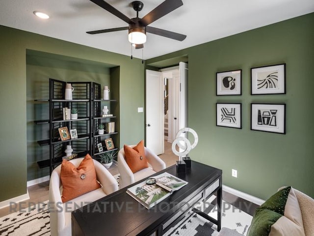 office featuring a ceiling fan and baseboards