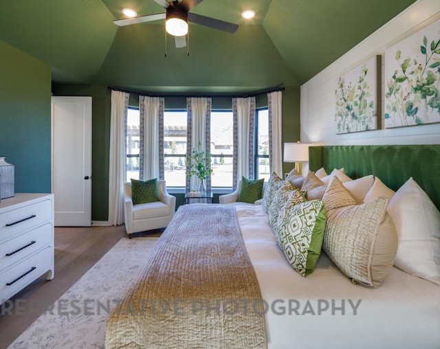 bedroom with a ceiling fan, lofted ceiling, and wood finished floors