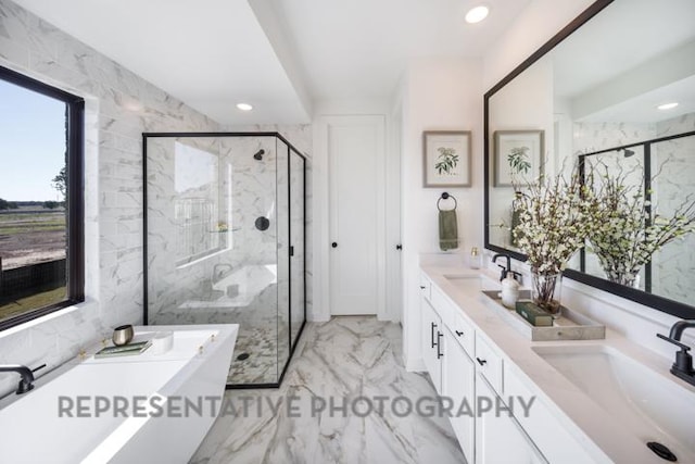 full bathroom featuring a freestanding bath, marble finish floor, a marble finish shower, and a sink