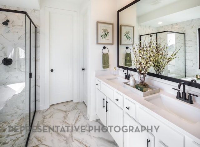 bathroom featuring a sink, a marble finish shower, marble finish floor, and double vanity