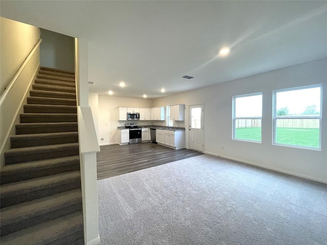 interior space featuring recessed lighting, white cabinets, appliances with stainless steel finishes, and baseboards