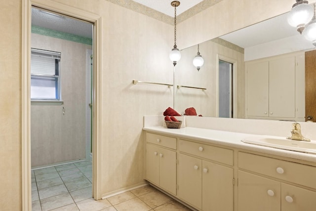 bathroom featuring tile patterned flooring, baseboards, vanity, an enclosed shower, and a textured ceiling