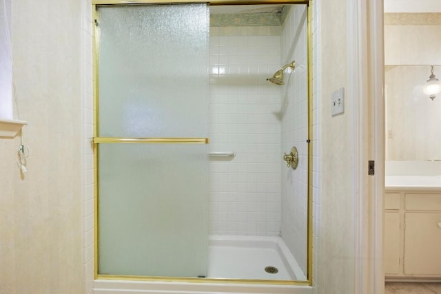 full bath featuring a stall shower and vanity