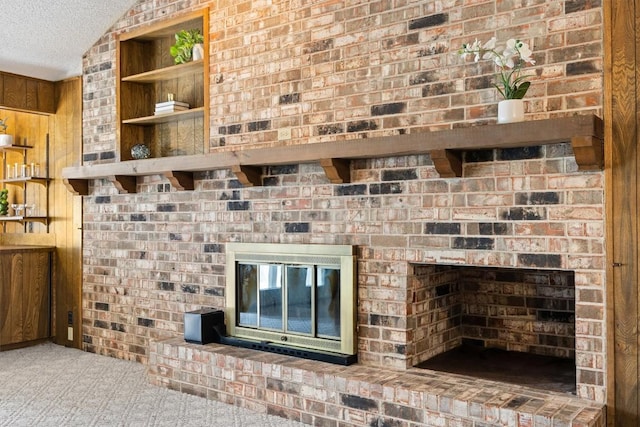 interior details with a textured ceiling, a fireplace, and carpet flooring