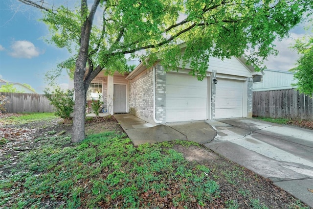 view of front of home with brick siding and fence