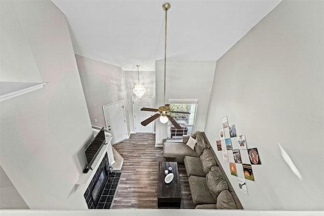 living room with a fireplace, heating unit, wood finished floors, and ceiling fan