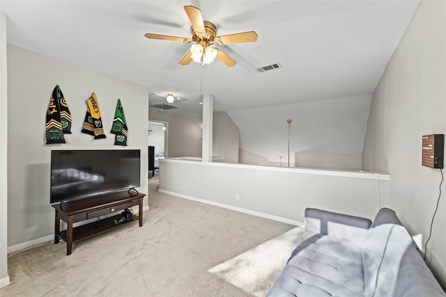 living area with visible vents, baseboards, carpet, vaulted ceiling, and a ceiling fan