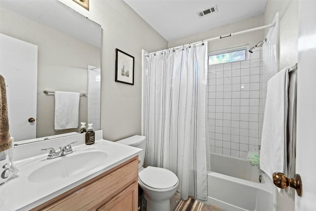 full bathroom featuring visible vents, toilet, vanity, and shower / bath combo