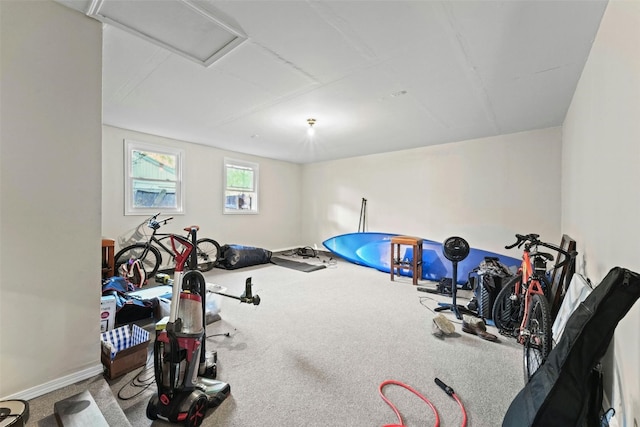 workout area with attic access, baseboards, and carpet floors