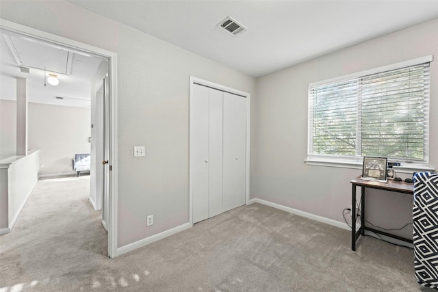 office space with attic access, baseboards, visible vents, and carpet floors