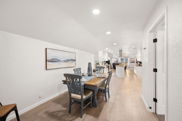 dining space with recessed lighting, baseboards, and light wood finished floors