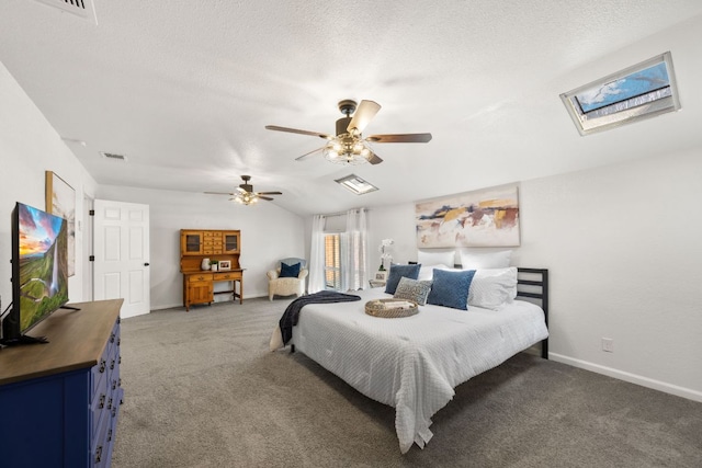 bedroom with visible vents, vaulted ceiling with skylight, light colored carpet, and baseboards