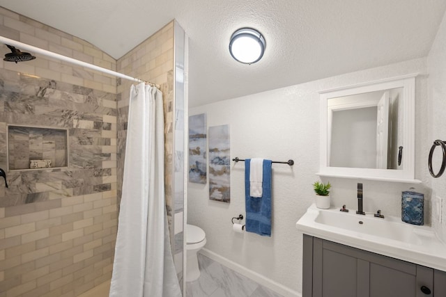 full bathroom with baseboards, toilet, tiled shower, marble finish floor, and vanity