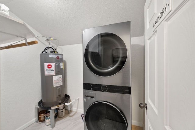 clothes washing area with stacked washer / dryer, electric water heater, baseboards, laundry area, and a textured ceiling