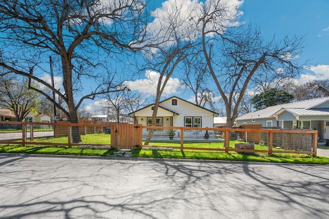 view of front of property with a fenced front yard and a gate