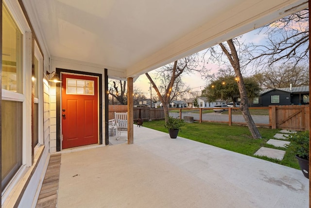 view of patio / terrace featuring a residential view and fence