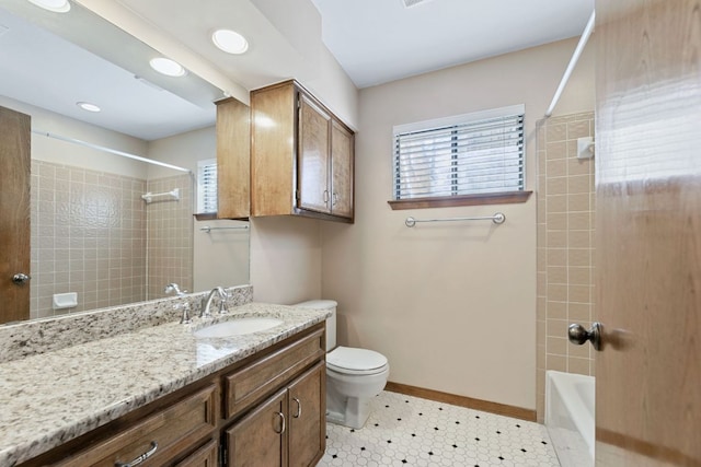 full bath with shower / bath combination, toilet, vanity, and baseboards