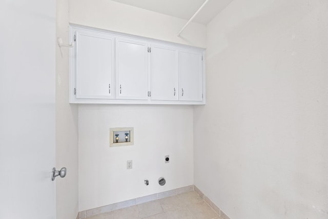 clothes washing area with washer hookup, hookup for a gas dryer, cabinet space, baseboards, and hookup for an electric dryer