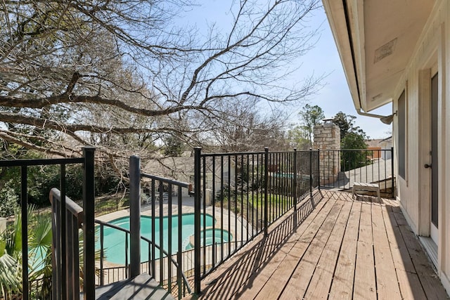 deck featuring a fenced in pool