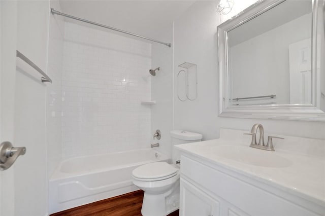 bathroom with shower / bath combination, toilet, wood finished floors, and vanity