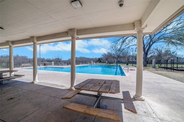 pool with a patio and a fenced backyard