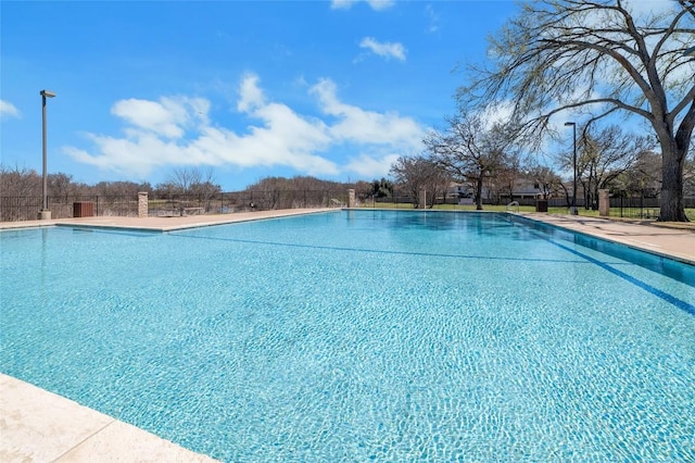 community pool featuring fence