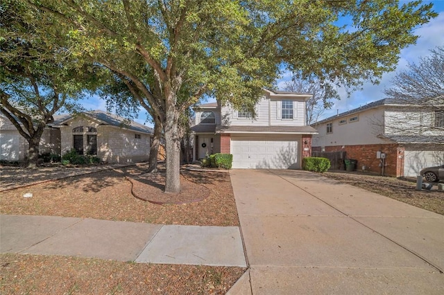 traditional-style house featuring concrete driveway, brick siding, and a garage