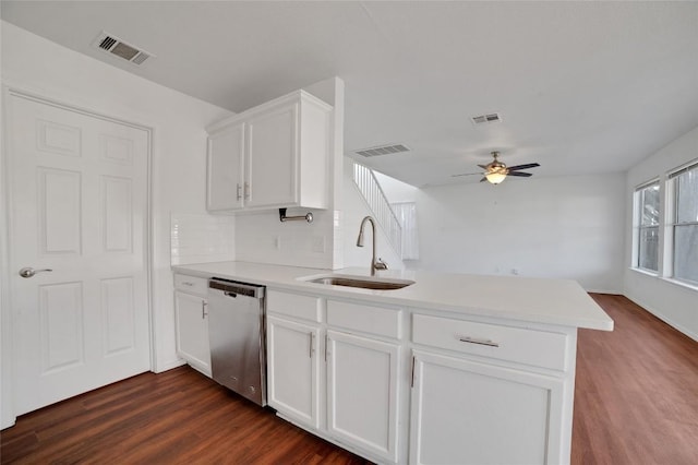 kitchen featuring visible vents, a peninsula, stainless steel dishwasher, and a sink