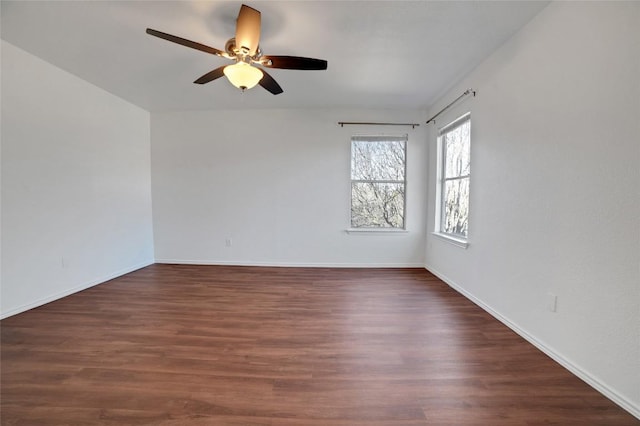 empty room featuring baseboards, ceiling fan, and wood finished floors