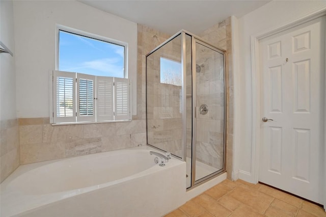 bathroom with a stall shower and a bath