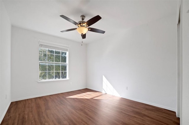 unfurnished room with wood finished floors, baseboards, and ceiling fan